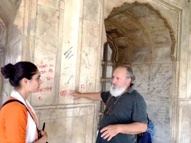 a foreign expert inspects a wall of shahi qila photo wlca a foreign expert inspects a wall of shahi qila photo wlca