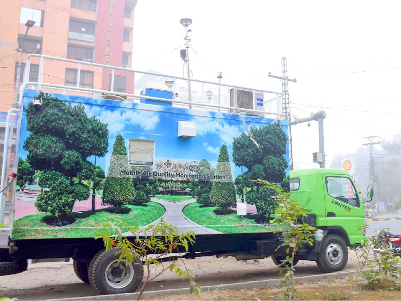 a mobile automatic air quality monitoring station is parked along a road in lahore photo online