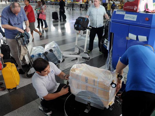 plastic wrapping prevents damage when handlers have to swiftly move bags on and off planes photo afp file