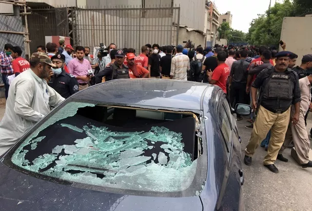 a plainclothes police officer l surveys the site of an attack at the pakistan stocks exchange entrance in karachi photo reuters a plainclothes police officer l surveys the site of an attack at the pakistan stocks exchange entrance in karachi photo reuters