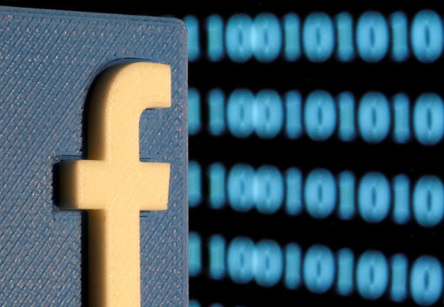 a 3 d printed facebook logo is seen in front of displayed binary code in this illustration picture june 18 2019 photo reuters a 3 d printed facebook logo is seen in front of displayed binary code in this illustration picture june 18 2019 photo reuters