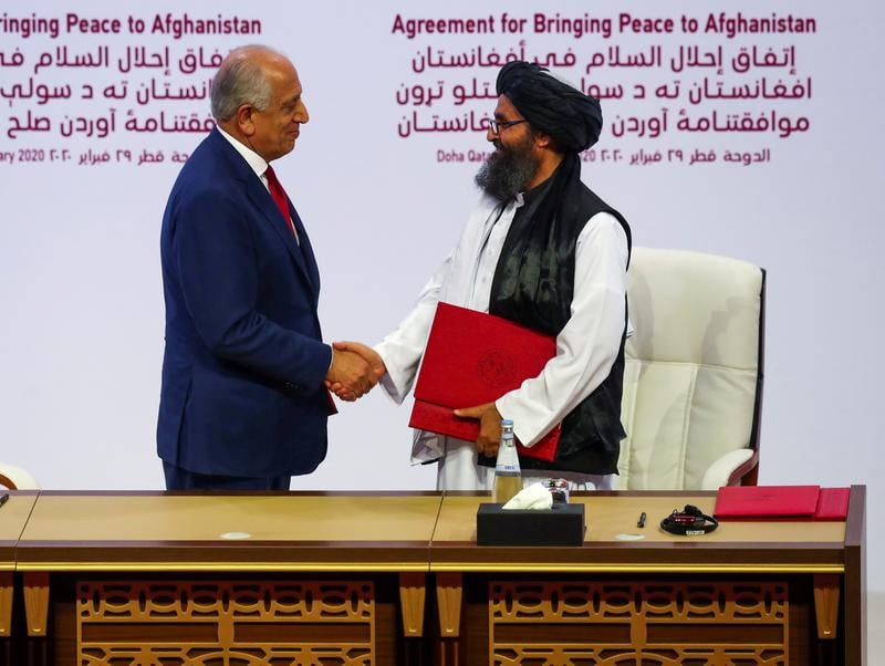 Mullah Abdul Ghani Baradar, the leader of the Taliban delegation, and Zalmay Khalilzad, US envoy for peace in Afghanistan, shake hands after signing an agreement at a ceremony between members of Afghanistan's Taliban and the US in Doha, Qatar February 29, 2020. [Photo: Reuters]