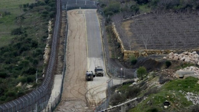 the fence separating the israeli annexed golan heights from syria is patrolled by israeli military vehicles photo afp the fence separating the israeli annexed golan heights from syria is patrolled by israeli military vehicles photo afp