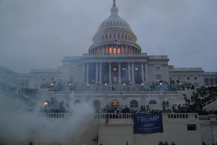 an explosion caused by a police munition is seen while supporters of u s president donald trump gather in front of the u s capitol building in washington u s january 6 2021 reuters