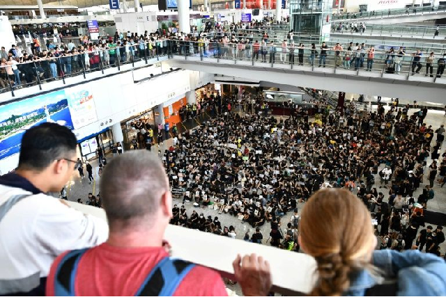 hong kong airport 039 s arrival hall echoed with anti government chants on friday photo afp