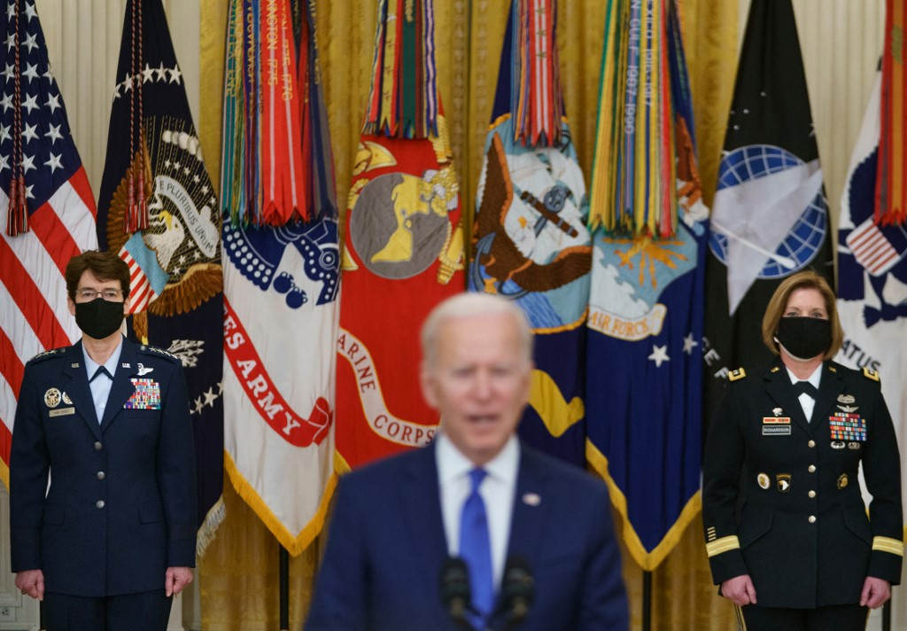 us president joe biden c speaks flanked by the nominees to positions as 4 star combatant commanders general jacqueline van ovost l and lieutenant general laura richardson r during international women s day in the east room of the white house in washington dc on march 8 afp