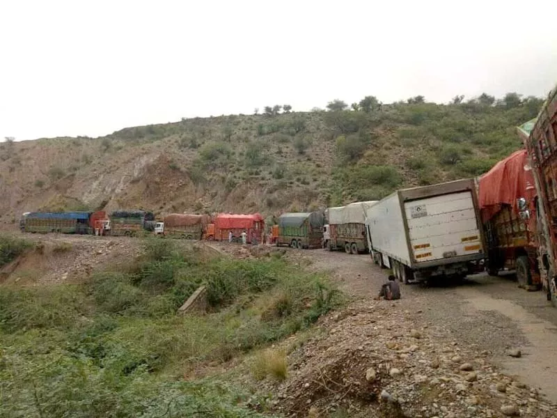 trucks and other vehicles wait as a landslide is cleared in di khan photo express trucks and other vehicles wait as a landslide is cleared in di khan photo express