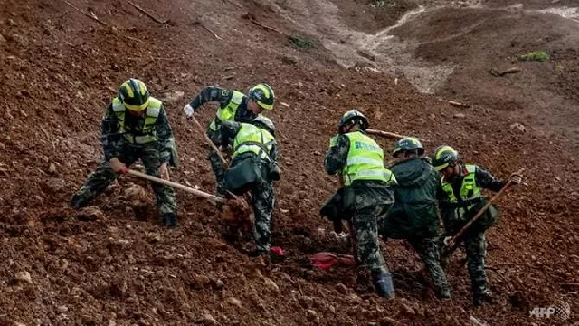 rescuers search through a landslide in a village in guizhou province photo afp rescuers search through a landslide in a village in guizhou province photo afp