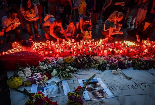people light candles at a makeshift memorial site in front of the romanian ministry of interior in bucharest photo afp people light candles at a makeshift memorial site in front of the romanian ministry of interior in bucharest photo afp