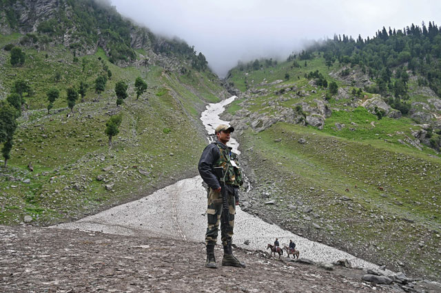 an indian border security force bsf soldier stands guard on a glacier at chandanwari some 115km southeast of srinagar photo afp