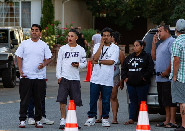 people look on from near the scene of a mass shooting during the gilroy garlic festival in gilroy california photo reuters people look on from near the scene of a mass shooting during the gilroy garlic festival in gilroy california photo reuters