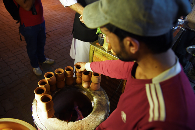 in this picture taken on march 29 2019 a pakistani worker places clay pots around a tandoor at a stall of a market in islamabad photo afp in this picture taken on march 29 2019 a pakistani worker places clay pots around a tandoor at a stall of a market in islamabad photo afp