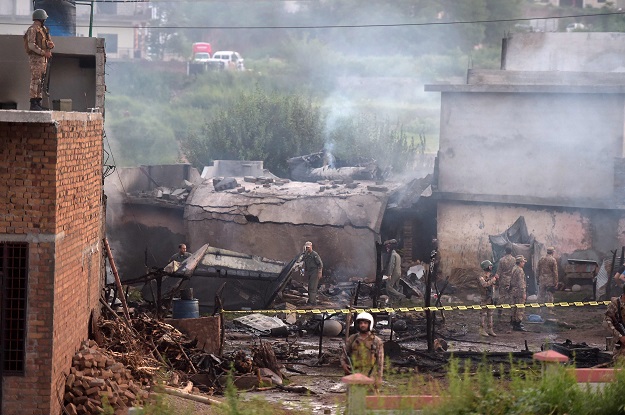 soldiers cordon off the site where a pakistani army aviation corps aircraft crashed in rawalpindi  afp