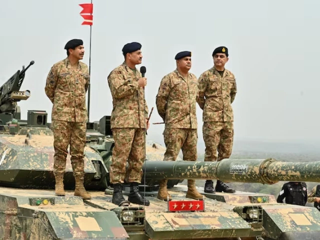 chief of army staff asim munir holds microphone during his visit at the tilla field firing ranges in mangla on may 1 photo reuters