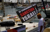 a banner with a message calling for the new zealand government to sanction israel hangs on a boat of a humanitarian flotilla preparing to depart for gaza in barcelona spain april 11 2026 photo reuters