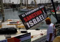 a banner with a message calling for the new zealand government to sanction israel hangs on a boat of a humanitarian flotilla preparing to depart for gaza in barcelona spain april 11 2026 photo reuters