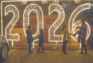 children pose in front of a beautifully illuminated wall bedecked with bright lights in celebration of the new year in the federal capital photo online