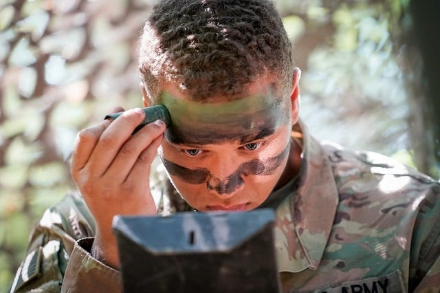 a soldier with the 3rd brigade combat team 101st airborne division air assault applies camouflage during expert infantryman badge training at fort campbell kentucky us photo reuters