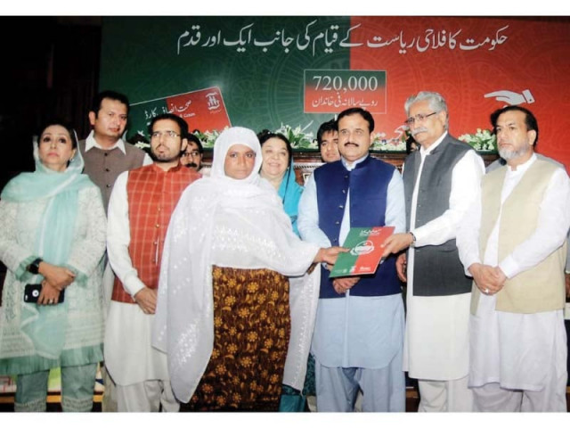 a woman receives a sehat card during a ceremony held at the main auditorium of the faisalabad medical university on friday photo app a woman receives a sehat card during a ceremony held at the main auditorium of the faisalabad medical university on friday photo app