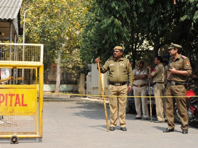 indian policemen stands guard near the site of gunfight between suspected militants and indian government forces photo afp