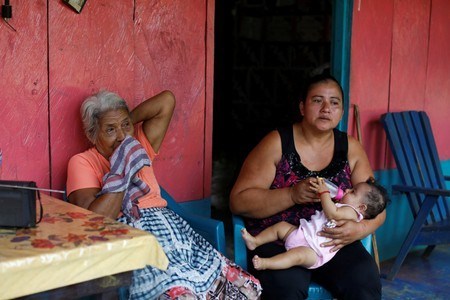 dolores morales lopez grandmother of guatemalan migrant ledy perez who was recently captured on camera by a reuters photographer pleading to mexico 039 s national guard to let her cross into the united states along her son anthony sits next to her granddaughter lolinda and great granddaughter marisol as pictured at her home in the community of santa amelia in la libertad municipality guatemala photo reuters