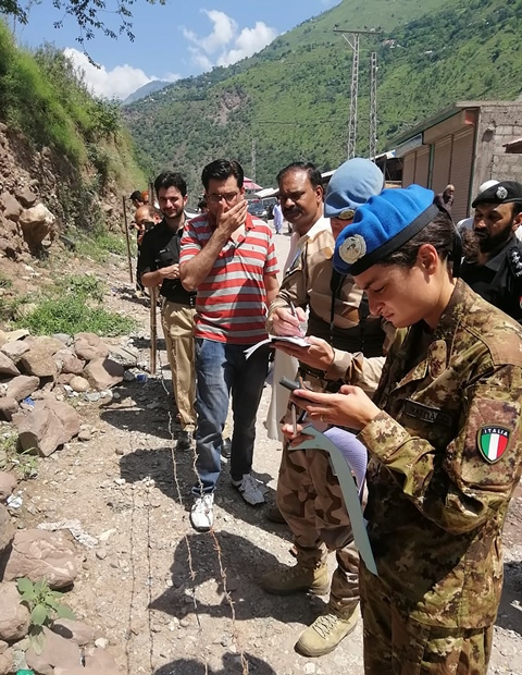 united nation representatives inspect the site of unexploded cluster bomb at loc in neelum valley some 36 km from muzaffarabad photo afp