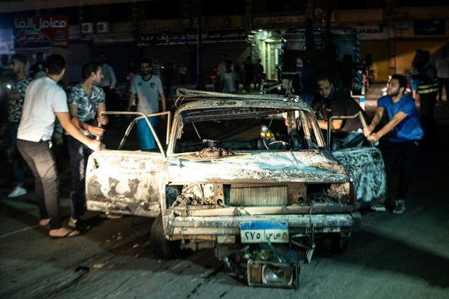 a picture taken early morning on august 5 2019 shows people surrounding a burned car after an accident that caused an explosion and killed 19 people in downtown cairo the accident was caused by a speeding car heading in opposite direction and colliding with three other cars which caused the explosion health ministry said in a brief note on their facebook page the incident resulted in 16 dead and 21 injured so far photo afp a picture taken early morning on august 5 2019 shows people surrounding a burned car after an accident that caused an explosion and killed 19 people in downtown cairo the accident was caused by a speeding car heading in opposite direction and colliding with three other cars which caused the explosion health ministry said in a brief note on their facebook page the incident resulted in 16 dead and 21 injured so far photo afp