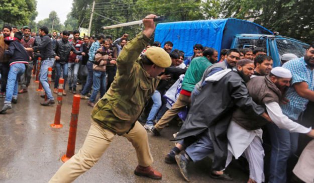 a police personnel caning protesters during a demonstration in srinagar photo reuters file