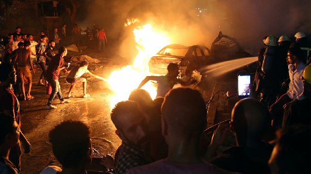 people extinguish the fire caused by the blast outside the national cancer institute in cairo photo reuters