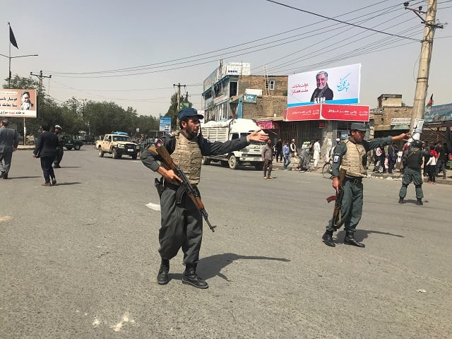 afghan policemen keep watch near the site of a blast in kabul afghanistan photo reuters