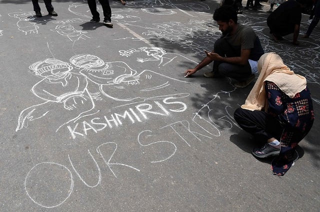 communist party of india cpi activists draw graffiti on the ground during a protest in new delhi on august 7 2019 in reaction to the indian government scrapping article 370 that granted a special status to jammu and kashmir photo afp