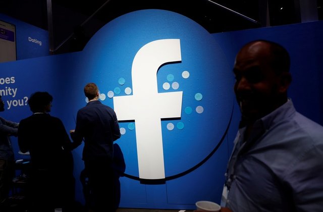 attendees walk past a facebook logo during facebook 039 s f8 developers conference in san jose california us april 30 2019 photo reuters