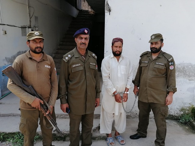 the accused is photographed with police personnel photo express