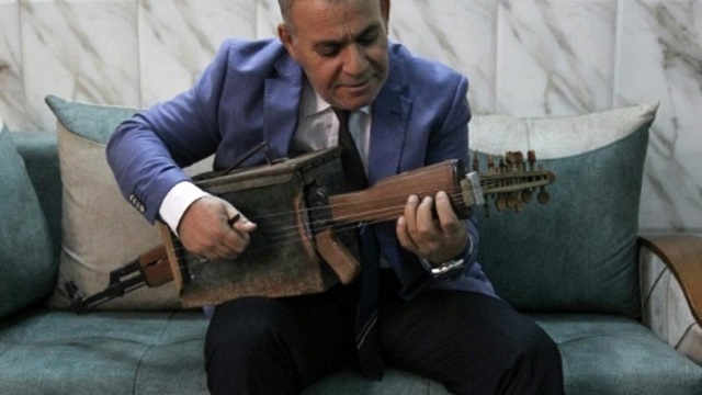 wearing a blue blazer and dark tie abdennour strummed the strings of his unusual instrument which has an ammunition case as a sound box photo afp