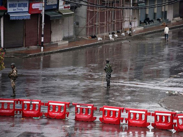 indian security force personnel stand guard in a deserted street during restrictions after india scrapped special status for iok august 8 2019 photo reuters