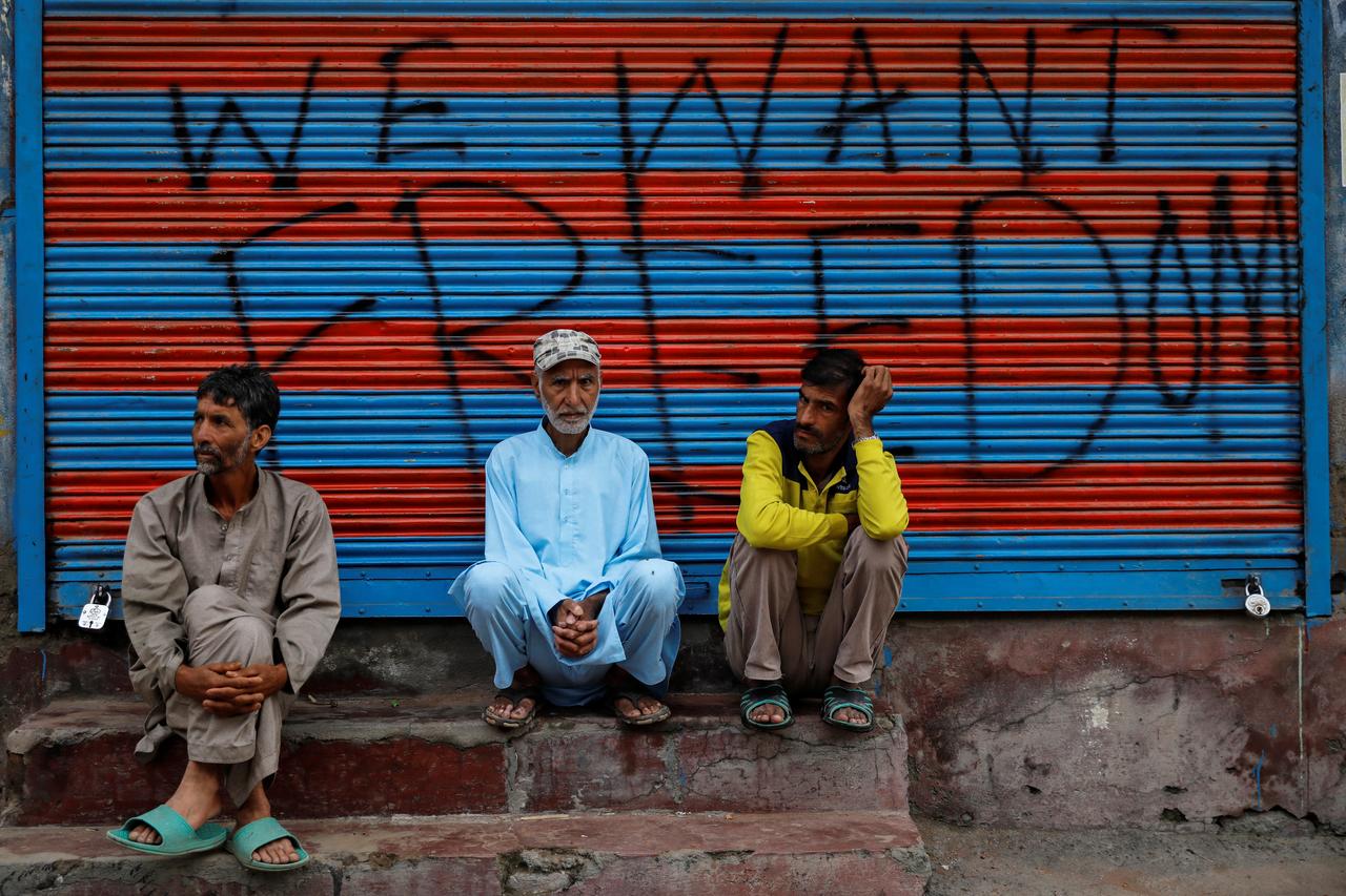 kashmiri men wait before eidul azha prayers during restrictions after the scrapping of the special constitutional status photo reuters