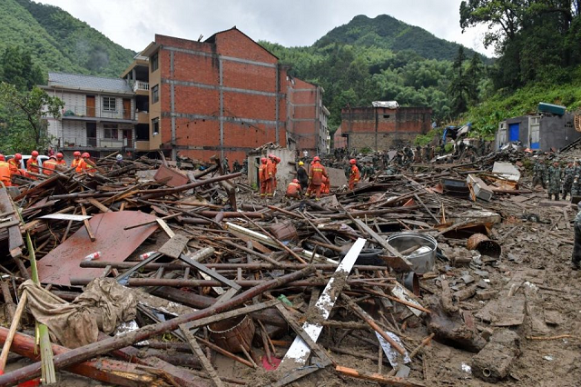 rescuers look for survivors in the rubble of damaged buildings after a landslide caused by torrential rain from typhoon lekima at yongjia in wenzhou in china s eastern zhejiang province on august 10 2019 photo afp rescuers look for survivors in the rubble of damaged buildings after a landslide caused by torrential rain from typhoon lekima at yongjia in wenzhou in china s eastern zhejiang province on august 10 2019 photo afp