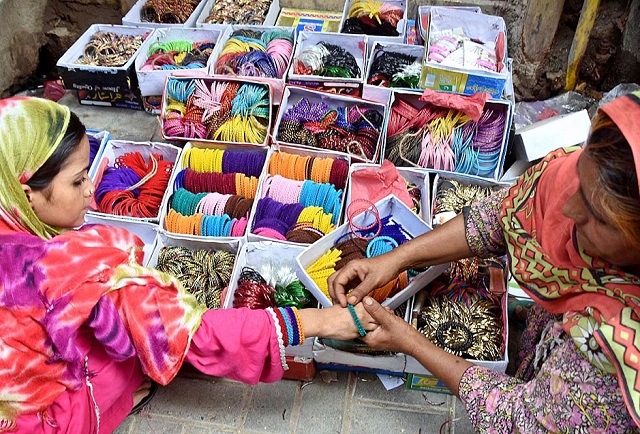 a young girl shopping for eid festivities at resham gali photo app