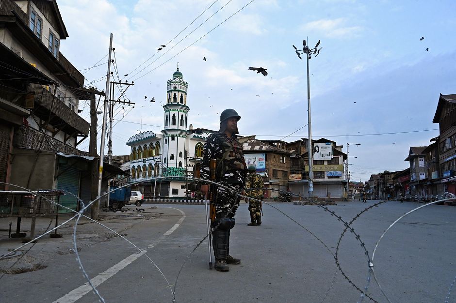 security personnel stand guard on a street during a lockdown in srinagar on august 12 2019 photo afp file