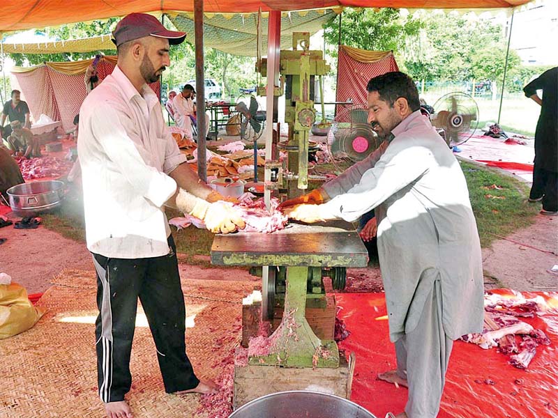 butchers use machines to cut beef on eidul azha photo app