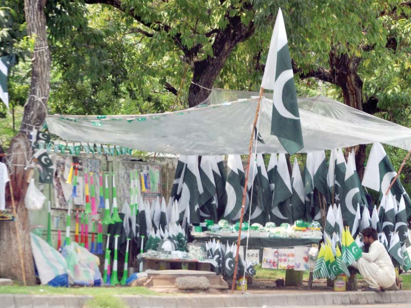 a vendor sells national flags in islamabad photo express