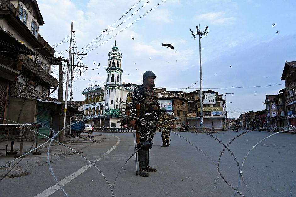 security personnel stand guard on a street during a lockdown in srinagar on august 12 2019 photo afp