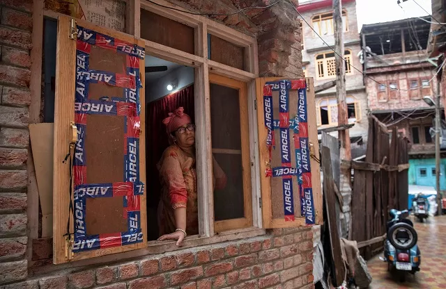 a kashmiri woman looks out of her house during restrictions after the scrapping of the special constitutional status for occupied kashmir by india in srinagar august 14 2019 photo reuters a kashmiri woman looks out of her house during restrictions after the scrapping of the special constitutional status for occupied kashmir by india in srinagar august 14 2019 photo reuters