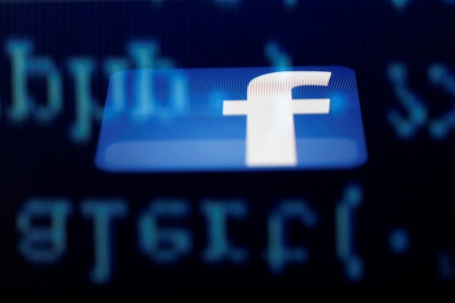 a facebook logo on an ipad is reflected among source code on the lcd screen of a computer in this photo illustration taken in sarajevo june 18 2014 photo reuters