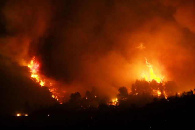 a fire fanned by a strong wind raged early thursday in the aude department of southern france photo afp