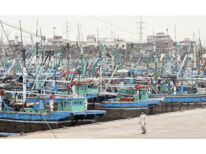 launches and boats stand parked at the fishing harbour awaiting their next trip to the deep sea photo express