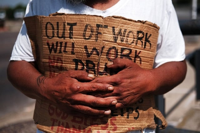 george who is homeless panhandles along a street in lawrence massachusetts lawrence once one of america s great manufacturing cities with immigrants from around the world coming to work in its textile and wool processing mills has struggled to find its economic base since the decline of manufacturing photo afp