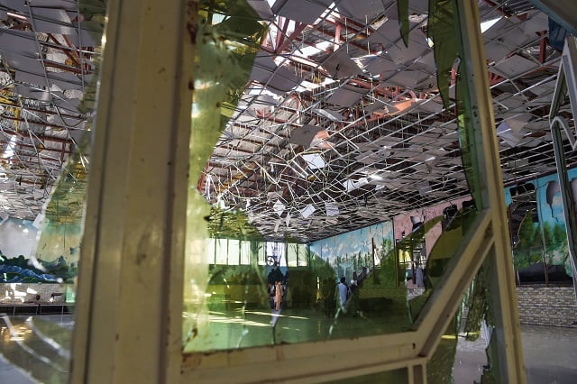 afghan men gather in a wedding hall after a deadly bomb blast in kabul photo afp