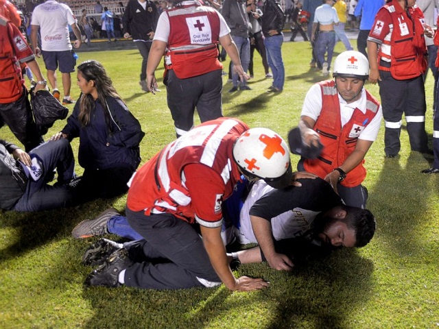 a spectator reacts from tear gas after three people died in riots before a soccer match when the fans attacked a bus carrying one of the teams at the national stadium in tegucigalpa honduras on saturday aug 17 2019 photo reuters