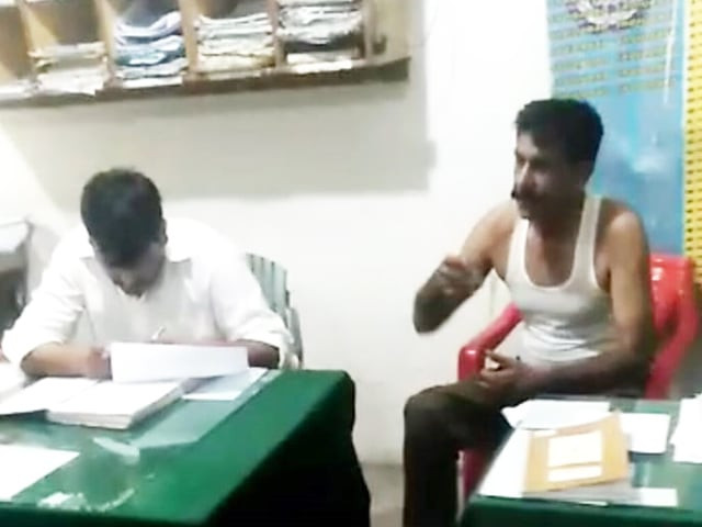 a screengrab of the viral footage of sub inspector right and the officer left in the rawalpindi police station photo express a screengrab of the viral footage of sub inspector right and the officer left in the rawalpindi police station photo express